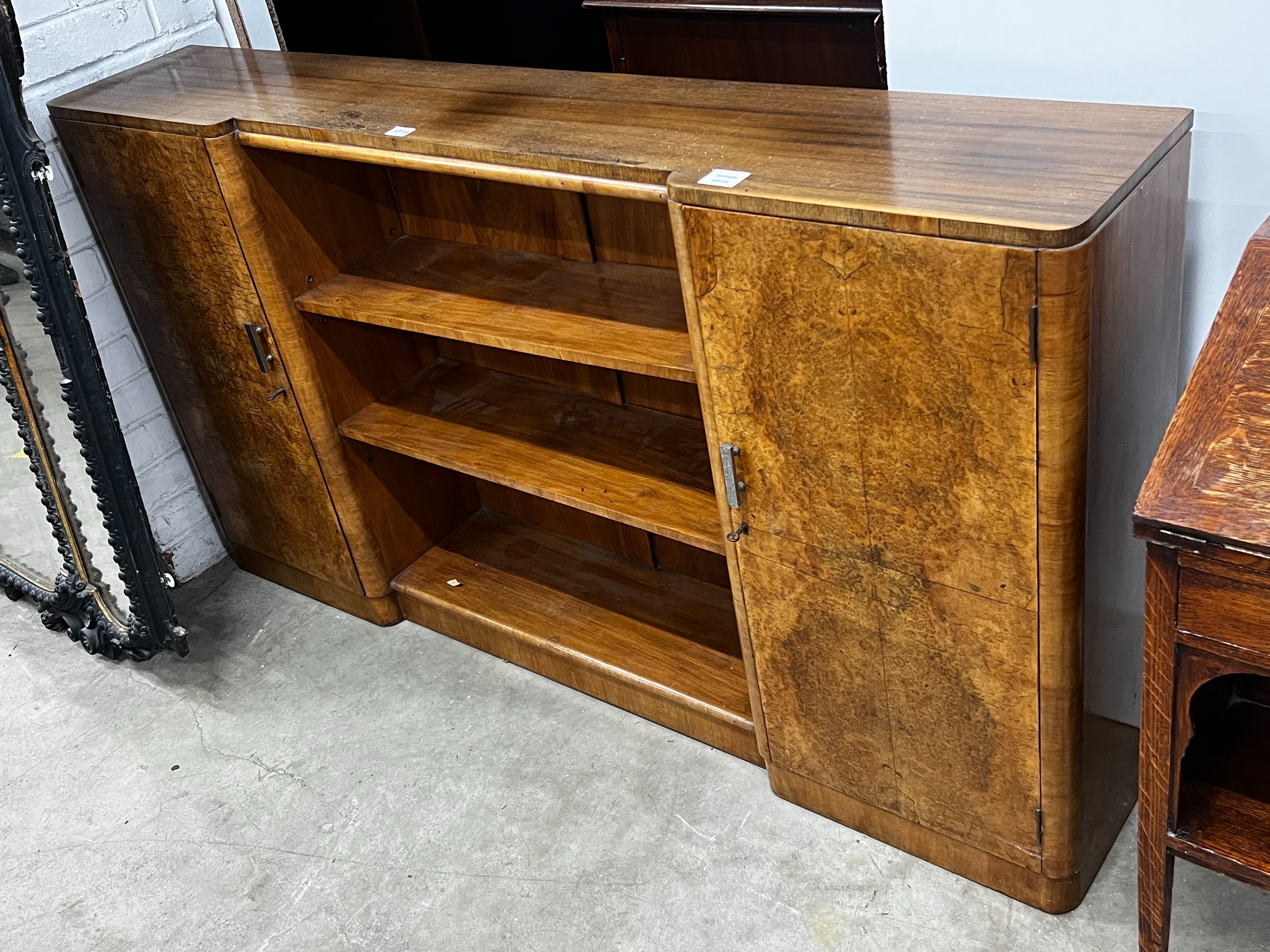 An Art Deco walnut dwarf bookcase, width 152cm, depth 27cm, height 84cm